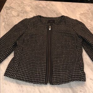 Tweed jacket with leather style trim.